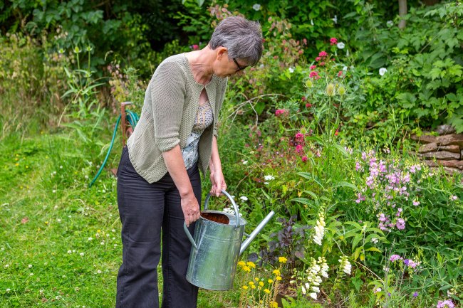 Photo of Janet Manning using a watering can